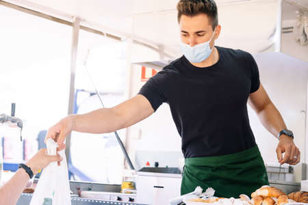 Food truck concept. Cook giving the food order to the customer.の写真素材