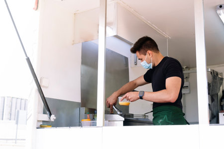 Food truck concept. Cook cooking on the griddle.の写真素材