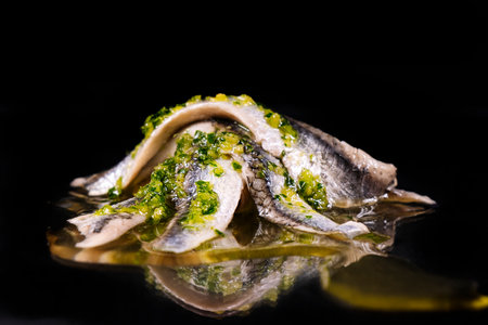 Pickled fish. Anchovies mounted together with a mince of garlic and parsley with olive oil.の写真素材