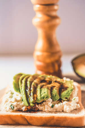 Partial view of a slice with cheese and avocado.の写真素材