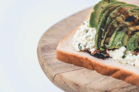 Partial view of a slice with cheese and avocado.の写真素材