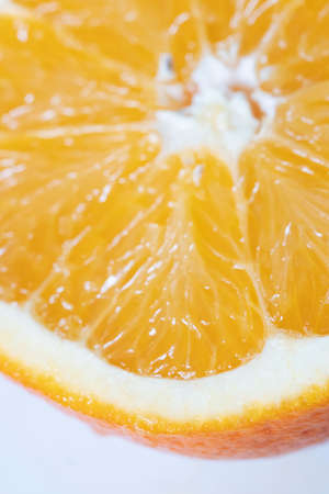 Half an orange levitating on white background.