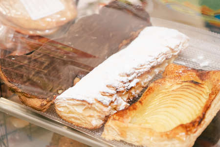 Cream pastries displayed in a pastry shop.