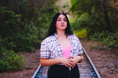 Teenager standing on some abandoned train tracks.の写真素材