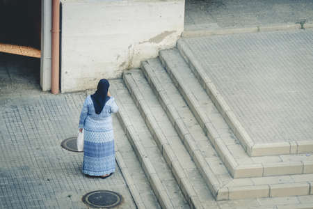 Muslim person from behind with head covered.の写真素材