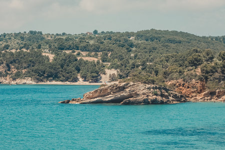 Islet on a beach in the rocky area of Catalonia, in Spain.