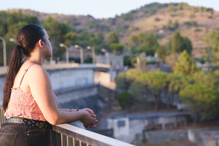 Teenager looking at infinity from a water dam.の写真素材
