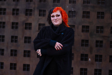 Portrait of a young transgender woman with dyed orange hair.の写真素材