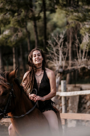 Amazon girl riding a horse in black dress.の写真素材
