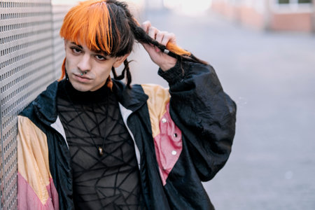 Close-up of boy with black and orange hair looking at camera.の写真素材