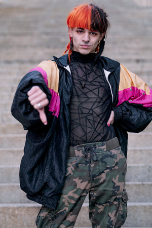 Portrait of a boy with urban appearance with hair painted with the thumb down.の写真素材