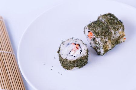 Salmon sushi with dill outside on white plate.の写真素材