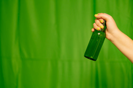A green bottle of beer with the background out of focus.