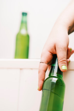 A green bottle of beer with the background out of focus.