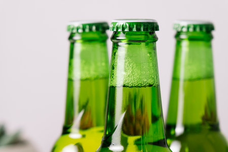 A green bottle of beer with the background out of focus.の写真素材
