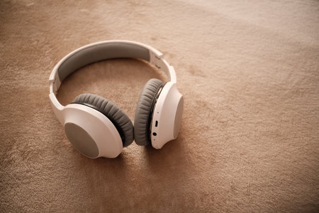 White headphones for listening to music lying on the bed.の写真素材