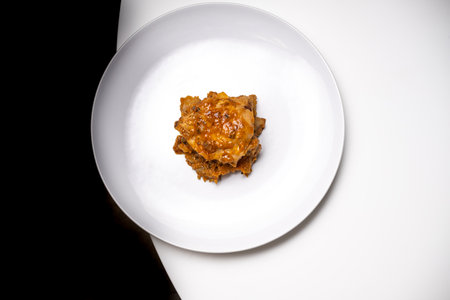 Meat dish with tomato on a black and white backgroundの写真素材