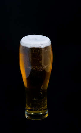 Full glass of beer on a black background