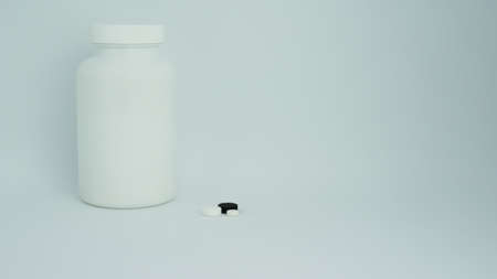 Empty white pharmaceutical bottle. Pills on white background Copy space for text Assorted pharmaceutical products Healthy eatingの写真素材