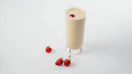 Yogurt in a glass with strawberries, fruit milk drink, on a white background.の写真素材