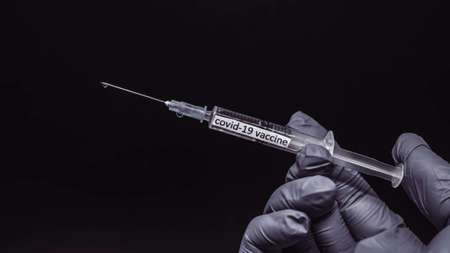 Vaccine against coronavirus infection, close-up, medicine for the disease in the hand of a doctor,...