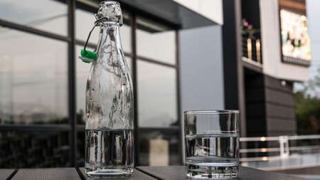 Mineral water in a glass and in a glass bottle close-upの写真素材