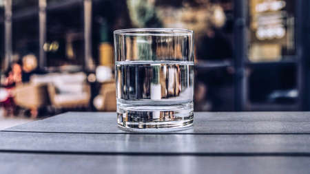 Drinking water in a glass in a restaurant in a cafe in a bar close-up of a glass with mineral waterの写真素材