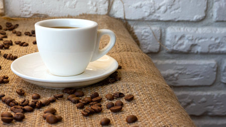 Coffee in a cup on a white brick wall background. A cup of coffee on a bar counter with a sprinkle...