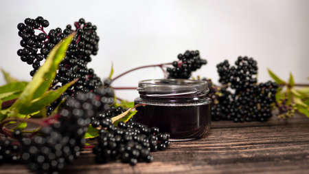 Elderberry tea, elderberry herbal tincture on wood background