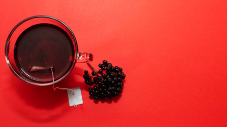 Top view of a mug of red tea. Natural herbal tea, medicinal from black elderberry berries. Homopathy.の写真素材