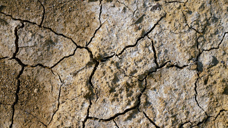 The soil of the earth is cracked, drought, the climate is changing. Top view of dried earth.