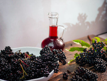 The black berry is medicinal. Ripe elderberry squeezed in syrup in a bottle. Natural black berry...