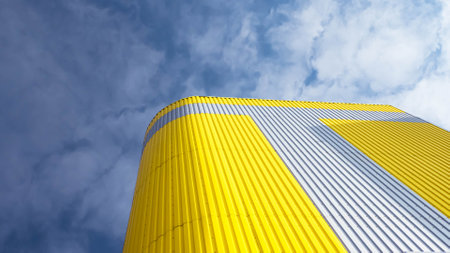 Modern building against the sky. High-rise building against a blue sky with white clouds.のeditorial素材