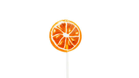 Orange lollipop on white background isolated. Fruit candy.の写真素材