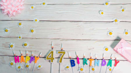 A beautiful card for a birthday in pastel colors in pink shades with a number  47. The decorations of their candles are festive from above, for a couple or a woman with a happy biの写真素材