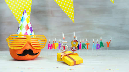 Happy birthday card with number 58. Copy space, beautiful birthday greeting character with mustache in glasses. Decorations with candles from numbers for a birthday.の写真素材