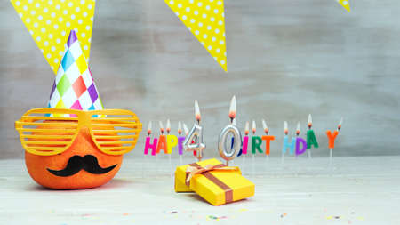 Happy birthday card with number 40. Copy space, beautiful birthday greeting character with mustache in glasses. Decorations with candles from numbers for a birthday.の写真素材