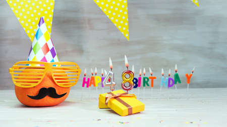 Happy birthday card with number 48. Copy space, beautiful birthday greeting character with mustache in glasses. Decorations with candles from numbers for a birthday.の写真素材