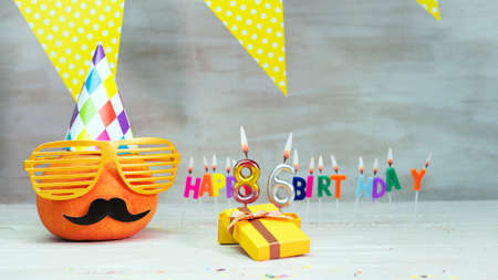Happy birthday card with number 86. Copy space, beautiful birthday greeting character with mustache in glasses. Decorations with candles from numbers for a birthday.の写真素材