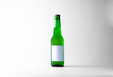 Frozen steamed green beer bottle on a white background with traces of ice.の写真素材