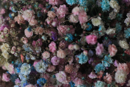 colorful artificial flowers in the market for use as background imageの写真素材