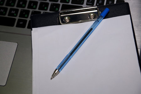 Pencil on blank paper on laptop keyboard. top view. business conceptの写真素材