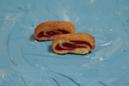 cookies with jam on a blue background, closeup of photoの写真素材