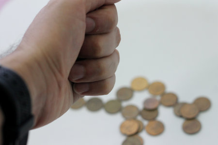 Man hand counting coins on white background, business and finance concept.の写真素材