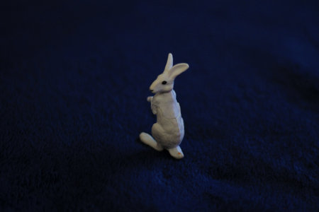 Rabbit figurine on a blue background. selective focus.の写真素材