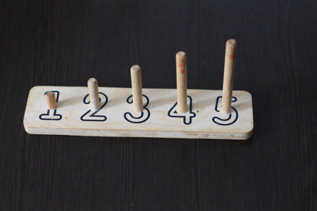Wooden Hanukkah candles on black wooden background. top view