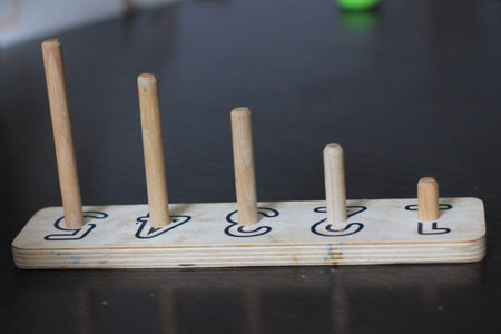 Wooden dominoes on a table in a children's roomの写真素材