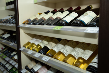 Shelves with bottles of wine on shelves in a wine store