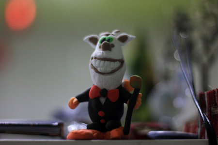 a close up of a plasticine figurine with a book in the backgroundの写真素材