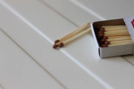 Box of matches on a white wooden background. close-up.の写真素材